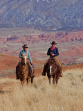 Cowboy and Cowgirl Riding Through Scenic Hills of the Big Horn Mountains, Shell, Wyoming, USA Photographie par Joe Restuccia III