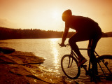 Silhouette of Mountain Biker at Sunset Photographic Print