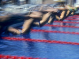 Blurred Action of Male Swimmers at the Start of a Race Photographic Print