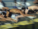 Blurred Action of Male Swimmers at the Start of a Race Photographic Print