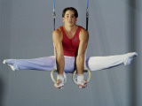 Male Gymnast Performing on the Rings Photographic Print