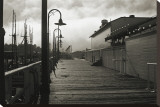 San Francisco Pier with Incoming Fog Stretched Canvas Print by Christian Peacock