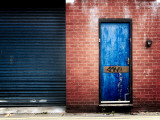 Derelict Door with Graffiti Photographic Print by Clive Nolan