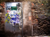 Derelict Door with Graffiti 3 Photographic Print by Clive Nolan