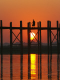 Myanmar (Burma), Amarapura, Taungthaman Lake, U Bein's Bridge, a Monk Walking Home at Sunset Photographic Print by Katie Garrod
