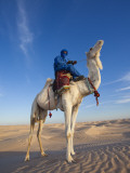 Tunisia, Sahara Desert, Douz, Great Dune, Rider and Camel Photographic Print by Walter Bibikow