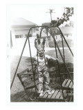 Boy with Indian Headdress on Swing Set Posters