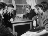 Technical Institute Students Passing Time by Playing Chess in Room at School's Dormitory Premium Photographic Print Technical Institute Students Passing Time by Playing Chess in Room at School's Dormitory Premium Photographic Print