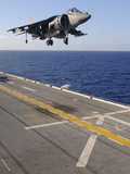 An AV-8B Harrier Jet Prepares to Land on the Flight Deck of USS Essex Photographic Print by  Stocktrek Images