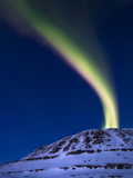 An Aurora Borealis Shooting Up from Toviktinden Mountain, Norway Photographic Print by  Stocktrek Images