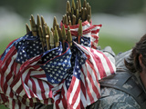 An Army Soldier's Backpack Overflows with Small American Flags Photographic Print by  Stocktrek Images