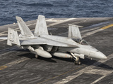 An Aircraft Director Guides an F/A-18F Super Hornet Aboard Aircraft Carrier USS Nimitz Photographic Print by  Stocktrek Images