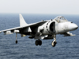 An AV-8B Harrier Hovers over the Flight Deck of USS Peleliu Photographic Print by  Stocktrek Images
