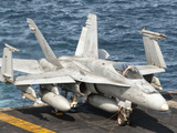 A US Navy F/A-18C Hornet Tied on the Flight Deck of USS Nimitz Photographic Print by  Stocktrek Images