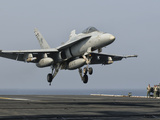 A US Navy F/A-18C Hornet Prepares to Land Aboard USS Eisenhower Photographic Print by  Stocktrek Images