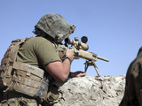 A U.S. Marine Looks Through the Scope of an M40A1 Sniper Rifle Photographic Print by  Stocktrek Images