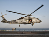 A US Navy SH-60F Seahawk Hovers Above the Flight Deck of USS Eisenhower Photographic Print by  Stocktrek Images