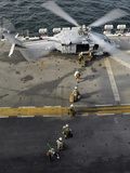 Marines Prepare to Board an MH-60S Sea Hawk Helicopter Aboard USS Peleliu Photographic Print by  Stocktrek Images