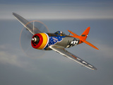 A Republic P-47D Thunderbolt in Flight Photographic Print by  Stocktrek Images
