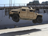 A Crane Lifts an M998 Humvee on the Flight Deck of USS Carter Hall Photographic Print by  Stocktrek Images