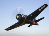 A Grumman F8F Bearcat in Flight Photographic Print by  Stocktrek Images