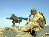 A Gunner Sits Atop a British Army WMIK Land Rover Photographic Print by  Stocktrek Images