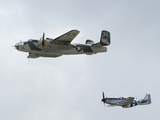 A B-25 Mitchell and a P-51 Mustang in Flight Lámina fotográfica por Raul Touzon