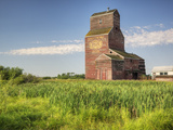 A Derelict Grain Elevator Weathers Away on the Canadian Prairie Photographic Print by Pete Ryan