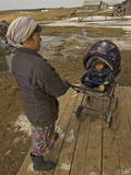 A Nenet Woman and Her Baby Wait Outside a Store in Snopa Village Photographic Print by Gordon Wiltsie