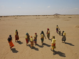 Gabra Women Carrying Heavy Jerry Cans Filled with Murky Water Photographic Print by Lynn Johnson