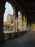 Three People Walking Underneath a Colonnade at the Plaza De Espana Photographic Print by Krista Rossow
