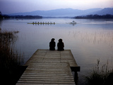 A Crew Boat and Women Sitting on a Dock on Lake Banyoles Photographic Print by Tino Soriano