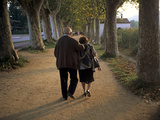 An Elderly Couple Walking Along a Tree-Lined Dirt Road Photographie par Tino Soriano