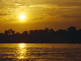 Sunset over Lowland Tropical Rainforest Along Amazon River, Amazon Basin, Brazil Photographic Print by Gerry Ellis