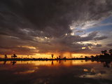Sunset and Storm Clouds over Waterhole, Linyanti Swamp, Okavango Delta, Botswana Photographic Print by Gerry Ellis