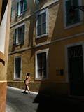 A Woman Walks on an Arles Street Near the Amphitheater Photographic Print by AJ Wilhelm