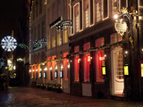 A Street Scene at Night During the Christmas Season Photographic Print by Abraham Nowitz