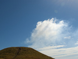 Blue Sky and Wispy Clouds over a Hill Photographic Print by Karen Kasmauski