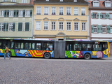 A Painted Double Long Bus in a Square in Heidelberg Photographie par Greg Dale