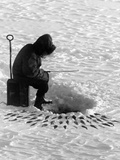 A Fisherman Fishes Through the Ice on Lake Huron Photographic Print by Thomas J. Abercrombie