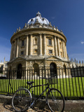 Bicycle Outside a Wrought Iron Fence around a Round Building Photographic Print by Joe Petersburger