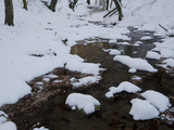 Stream Running Past Snow-Covered Stones and Banks Photographic Print by Joe Petersburger
