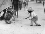A Young Guatemalan Boy in a Straw Hat Tries to Coax a Turkey to Him Photographie par Luis Marden