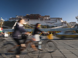 Bicyclists and Traffic in Front of the Potala Palace Photographic Print by Michael S. Yamashita