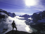 A Lone Climber Enjoys the View Above the Clouds Photographic Print by John Burcham