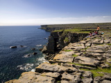 Tourists on the Edge of a Cliff on Inishmore Island Photographic Print by Chris Hill