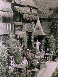 Waitresses Serve Customers at Outdoor Cafe under Chef's Watchful Eye Photographie par W. Robert Moore