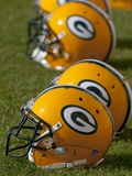 Packers Training Camp: Green Bay, WISCONSIN - Green Bay Packers Helmets Photographic Print by Mike Roemer