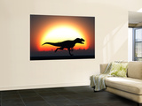 A Silhouetted Allosaurus Sprinting Against a Setting Set at the End of a Jurassic Day Reproduction murale géante par Stocktrek Images 