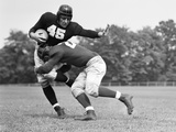 1940s Football Player Being Tackled Photographie par H. Armstrong Roberts